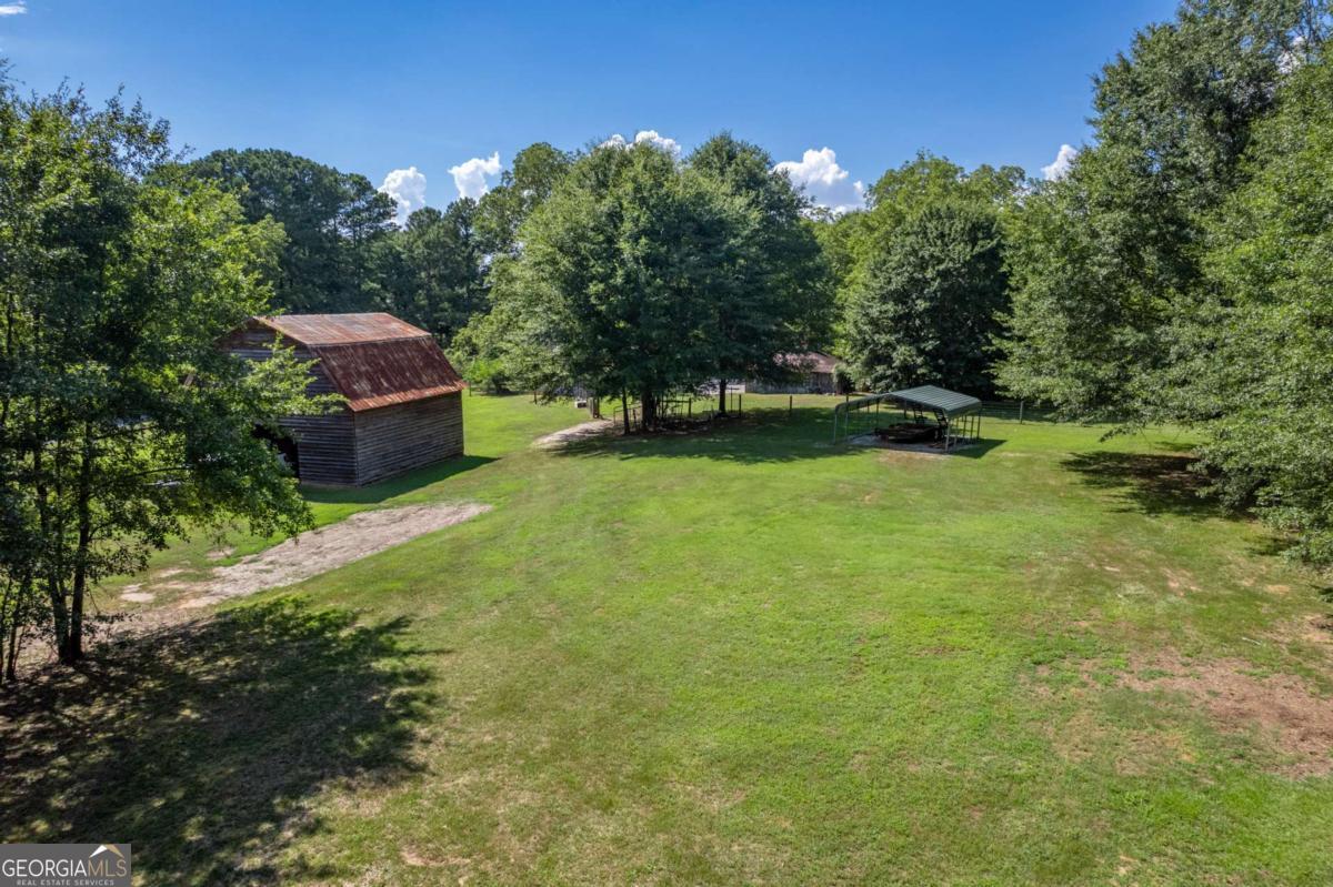 5380 Guthrie Road Loganville, GA 30052 - Photo 37 of 38 a backyard of a house with lots of green space