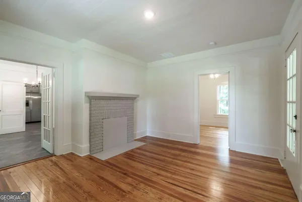 a view of an empty room and wooden floor