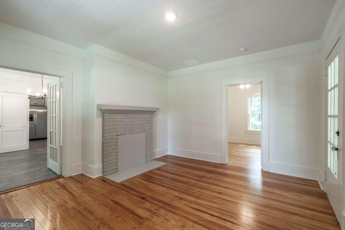5380 Guthrie Road Loganville, GA 30052 - Photo 8 of 38 a view of an empty room and wooden floor