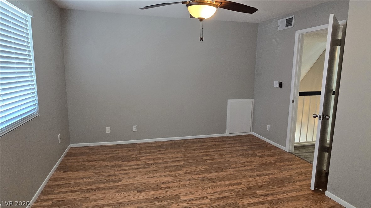 3849 Reflection Way Las Vegas, NV 89147 - Photo 15 of 25 An inviting room features resilient wood-look flooring and a ceiling fan, creating a comfortable atmosphere.