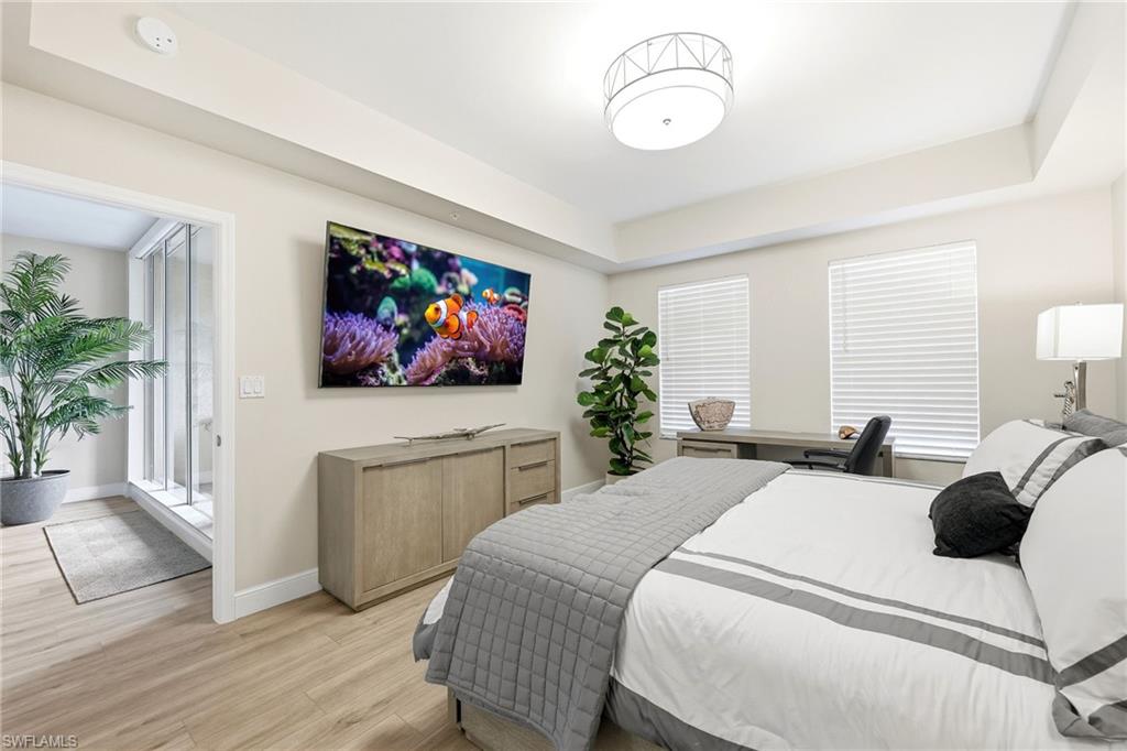 401 Bayfront Place, Unit 3307 Naples, FL 34102 - Photo 12 of 28 Bedroom with wood finished floors and a tray ceiling