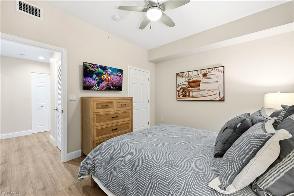 401 Bayfront Place, Unit 3307 Naples, FL 34102 - Photo 18 of 28 Bedroom featuring light wood-style floors and ceiling fan