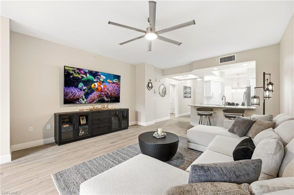 401 Bayfront Place, Unit 3307 Naples, FL 34102 - Photo 3 of 28 Living area featuring light wood finished floors and ceiling fan