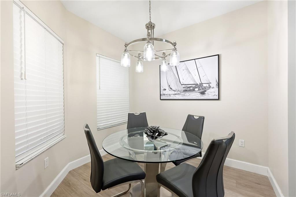 401 Bayfront Place, Unit 3307 Naples, FL 34102 - Photo 9 of 28 Dining room with light wood-style floors and a chandelier