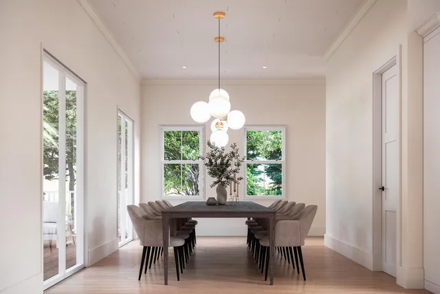 a dining room with furniture a chandelier and wooden floor