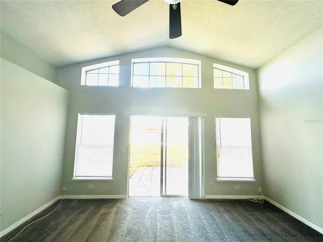 a kitchen with granite countertop a refrigerator stove and sink