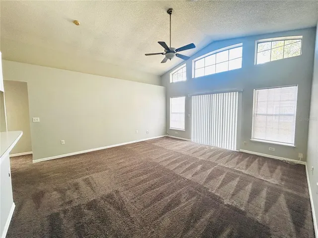 a kitchen with stainless steel appliances a refrigerator a stove a sink and white cabinets