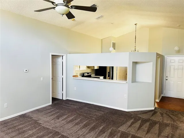 a kitchen with a refrigerator and a stove top oven