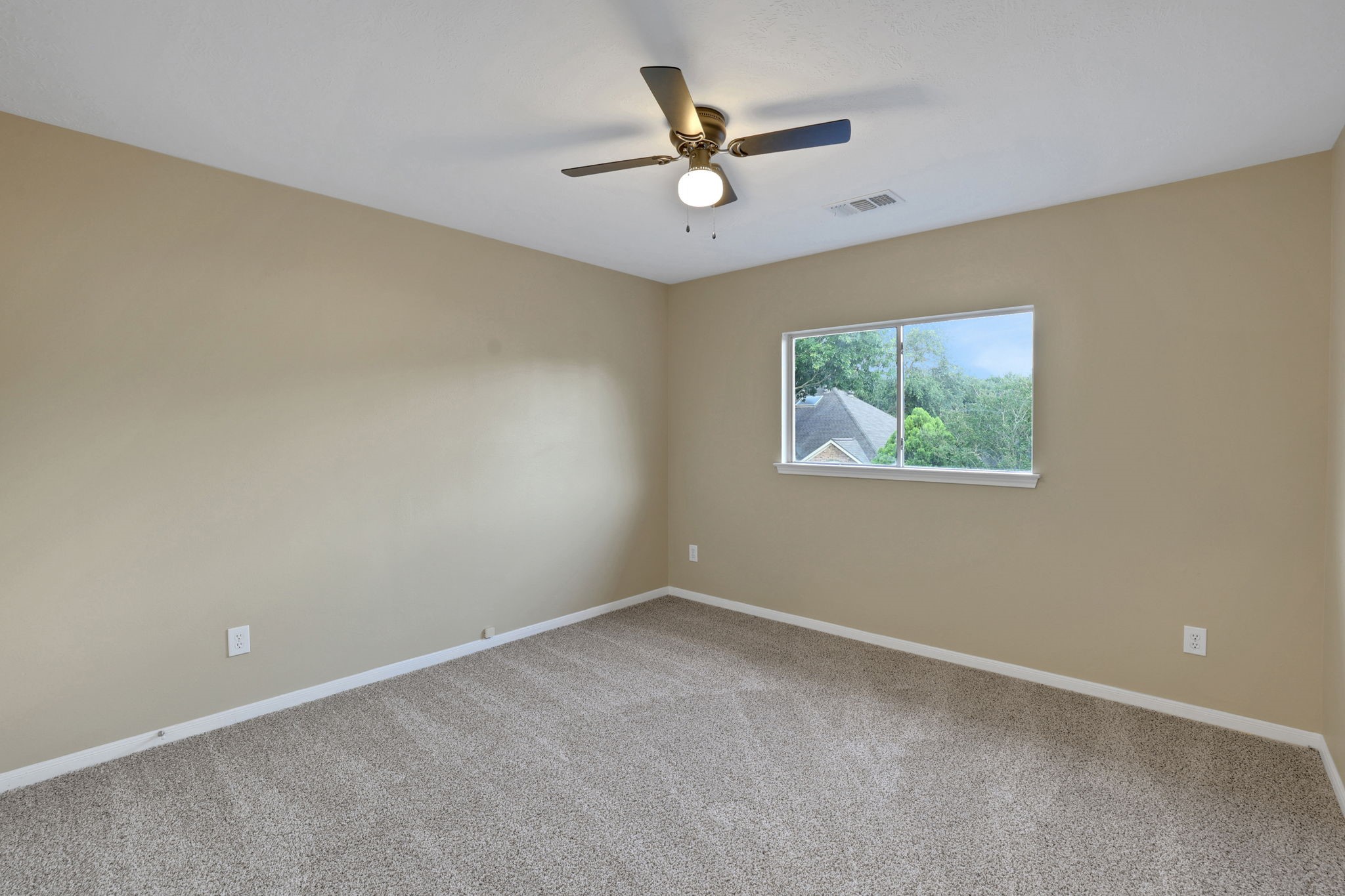 23207 Olive Ridge Court Katy, TX 77494 - Photo 40 of 46 an empty room with window and ceiling fan