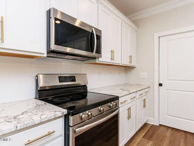 a kitchen with a stove and a microwave
