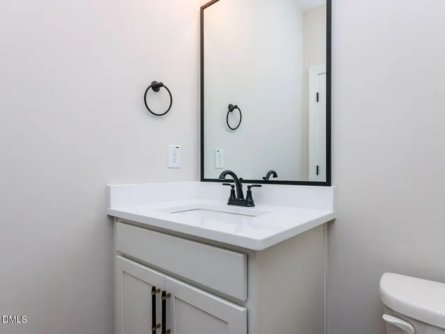 a bathroom with a sink and mirror
