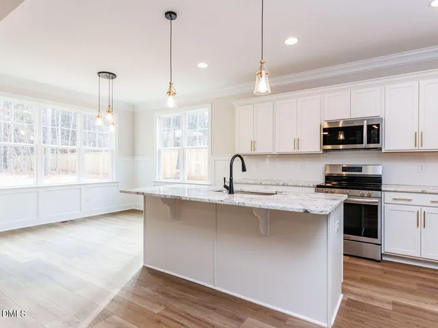 a kitchen with appliances a sink and cabinets