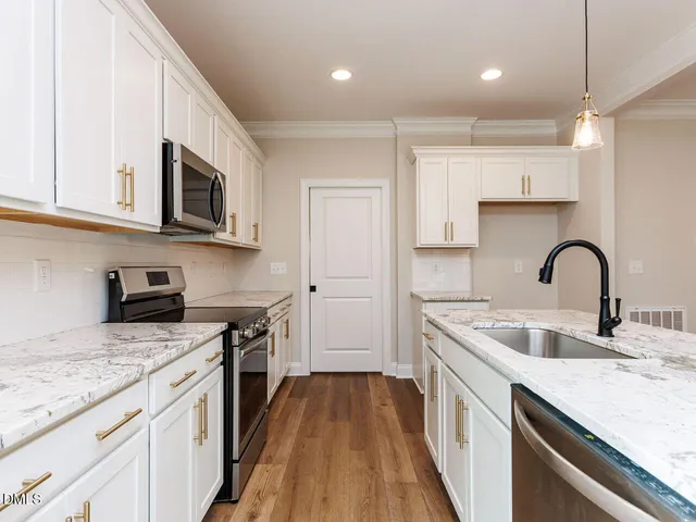 a kitchen with a sink a stove and cabinets