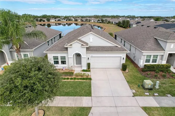 an aerial view of a house with a yard