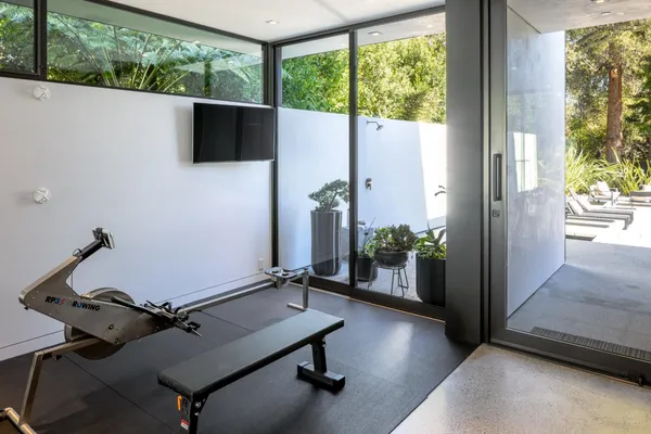 a room with pool table and windows