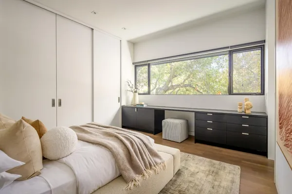 a bedroom with a bed and window