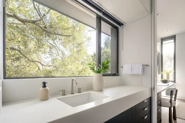 a kitchen with a sink and large window