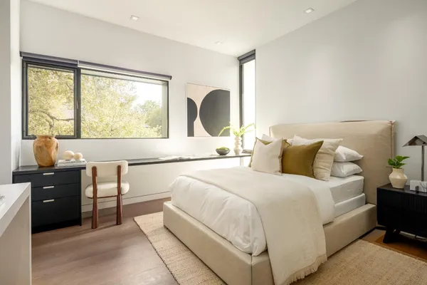 a bedroom with a bed and a large window