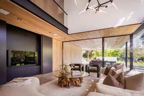 a living room with furniture and a floor to ceiling window