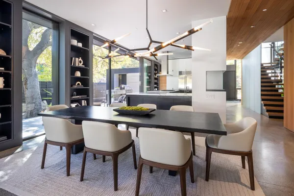 a dining room with furniture a chandelier and window