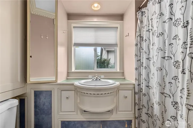 a bathroom with a sink a toilet and a mirror