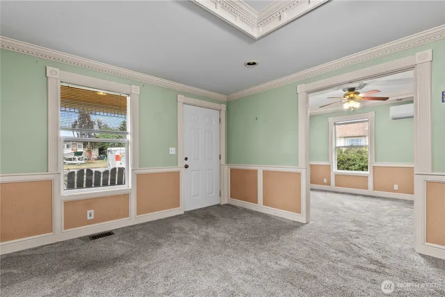 an empty room with closet and windows