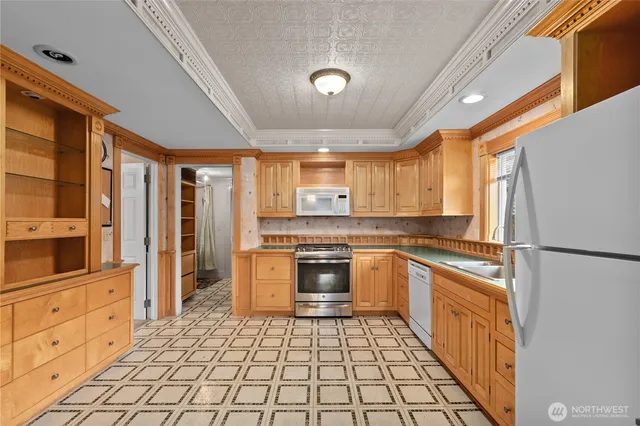 a kitchen with granite countertop appliances cabinets and a sink