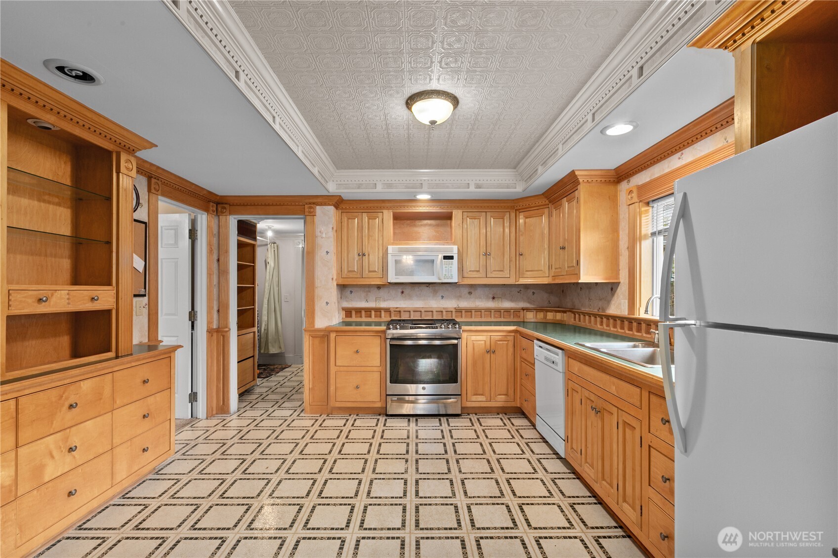 1108 18th Street Anacortes, WA 98221 - Photo 8 of 37 a kitchen with stainless steel appliances granite countertop a refrigerator and a stove top oven