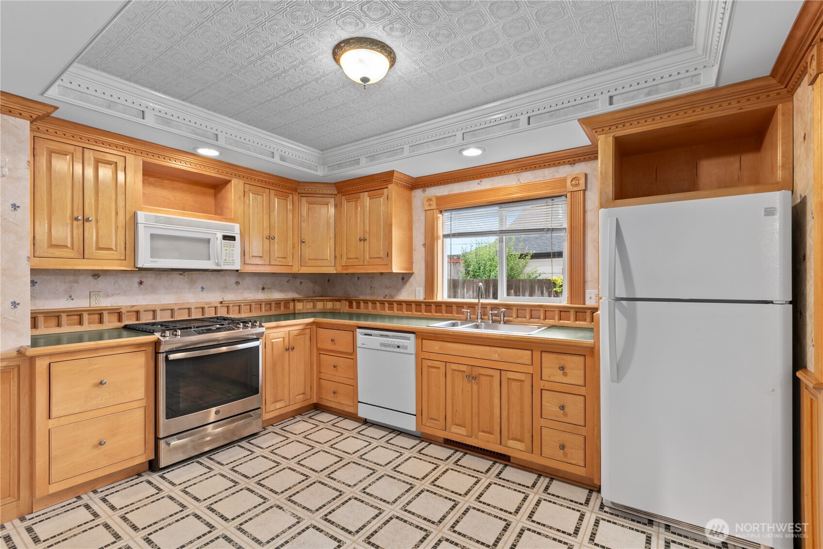 1108 18th Street Anacortes, WA 98221 - Photo 9 of 37 a kitchen with granite countertop appliances cabinets and a sink