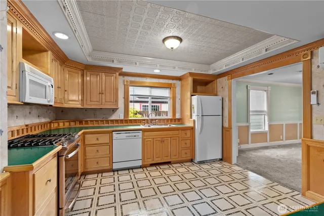 a kitchen with stainless steel appliances granite countertop a refrigerator and a stove top oven