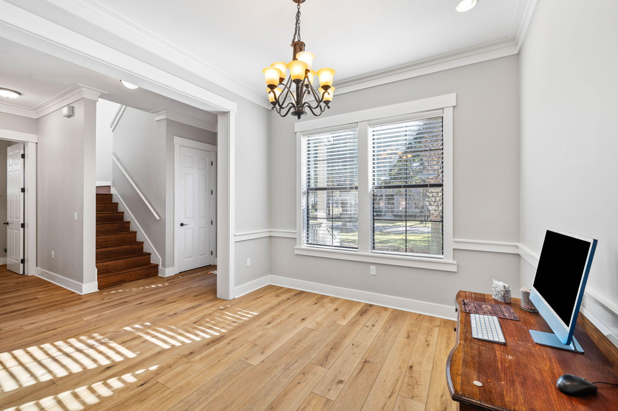 144 Preston Path Santa Rosa Beach, FL 32459 - Photo 26 of 60 a view of a livingroom with wooden floor and a chandelier