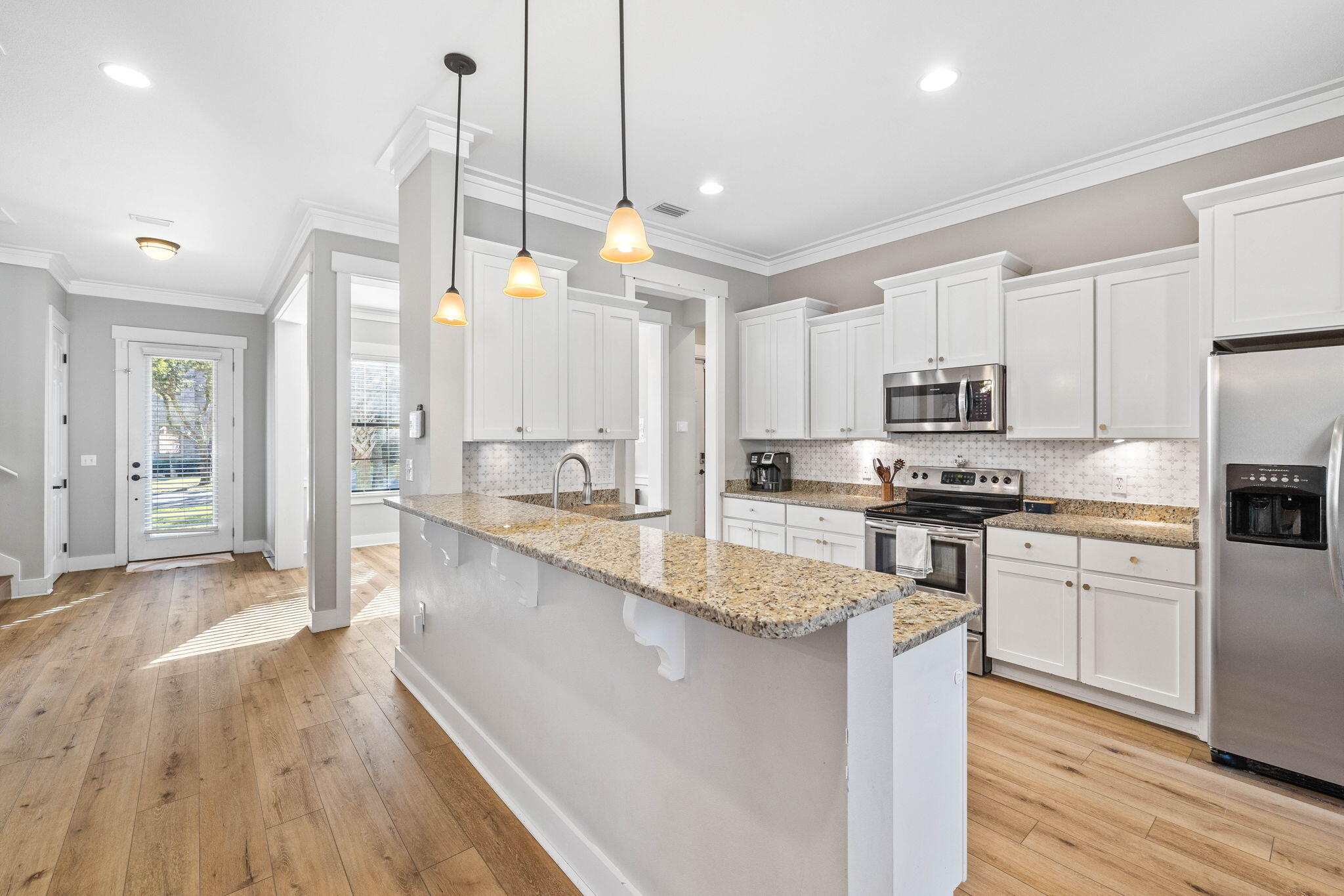 144 Preston Path Santa Rosa Beach, FL 32459 - Photo 32 of 60 a kitchen with stainless steel appliances kitchen island granite countertop a stove a sink a refrigerator a center island and cabinets