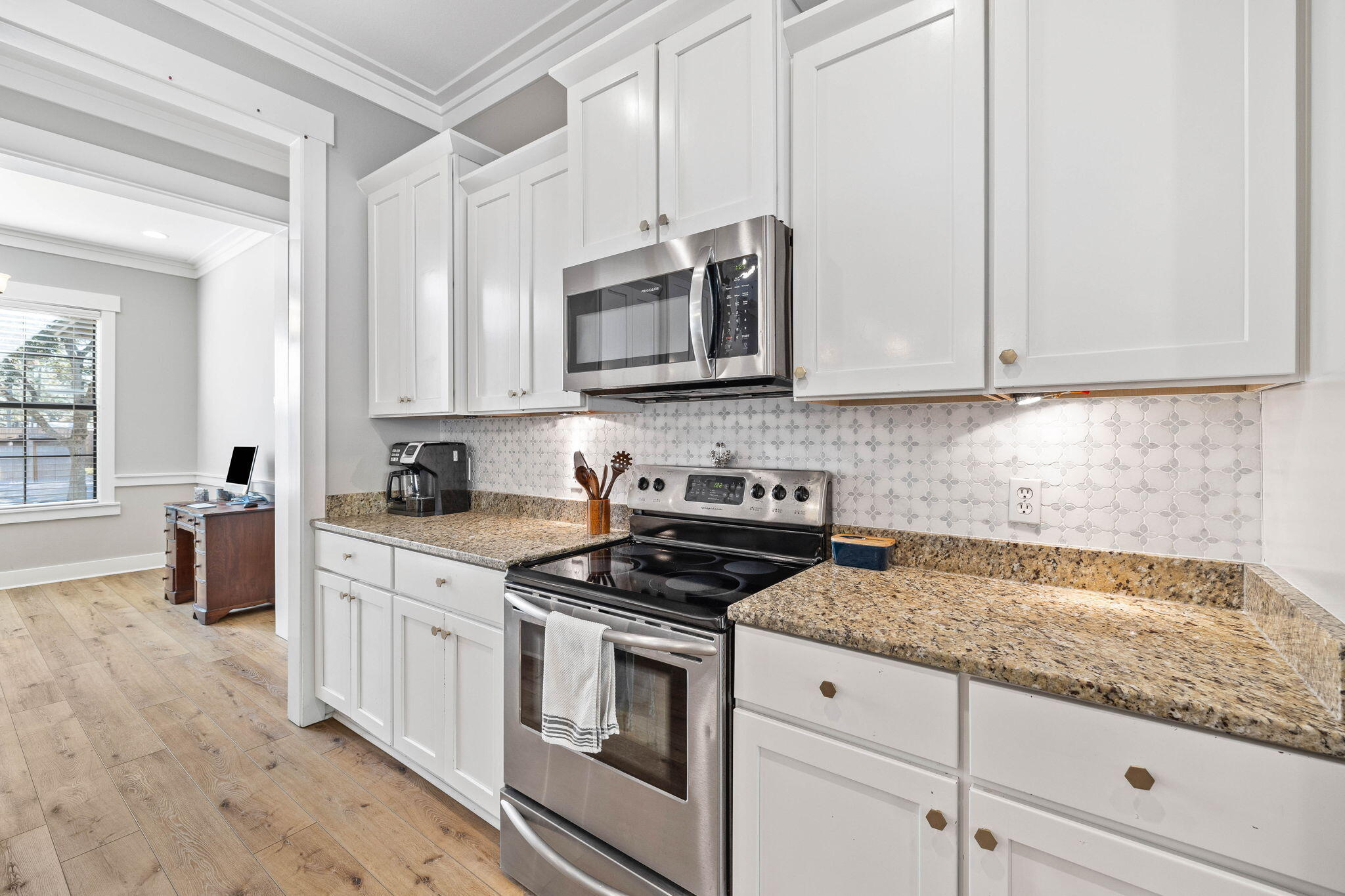 144 Preston Path Santa Rosa Beach, FL 32459 - Photo 34 of 60 a kitchen with granite countertop a stove sink and cabinets