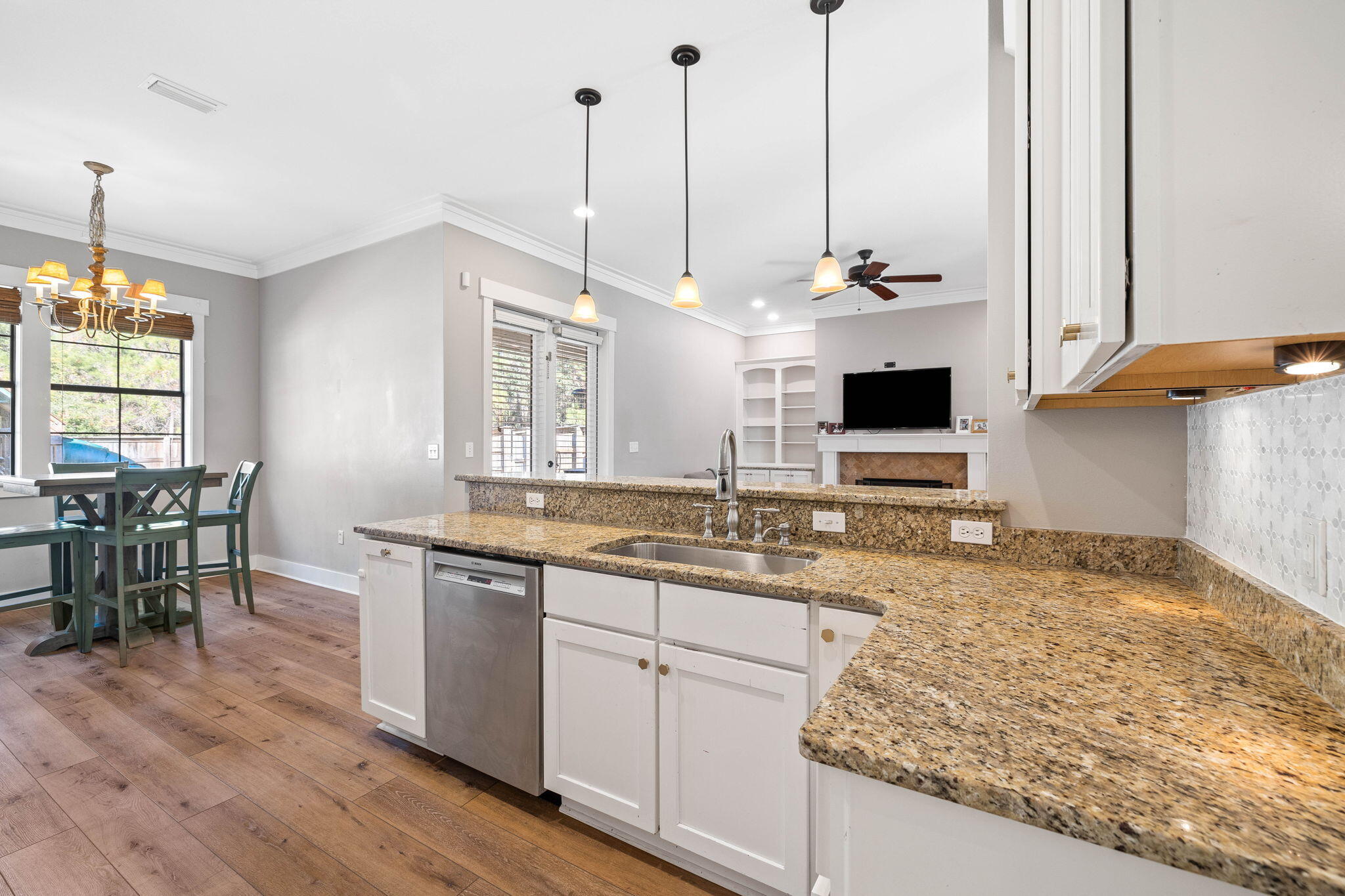 144 Preston Path Santa Rosa Beach, FL 32459 - Photo 35 of 60 a view of a kitchen with kitchen island granite countertop wooden floor and a sink
