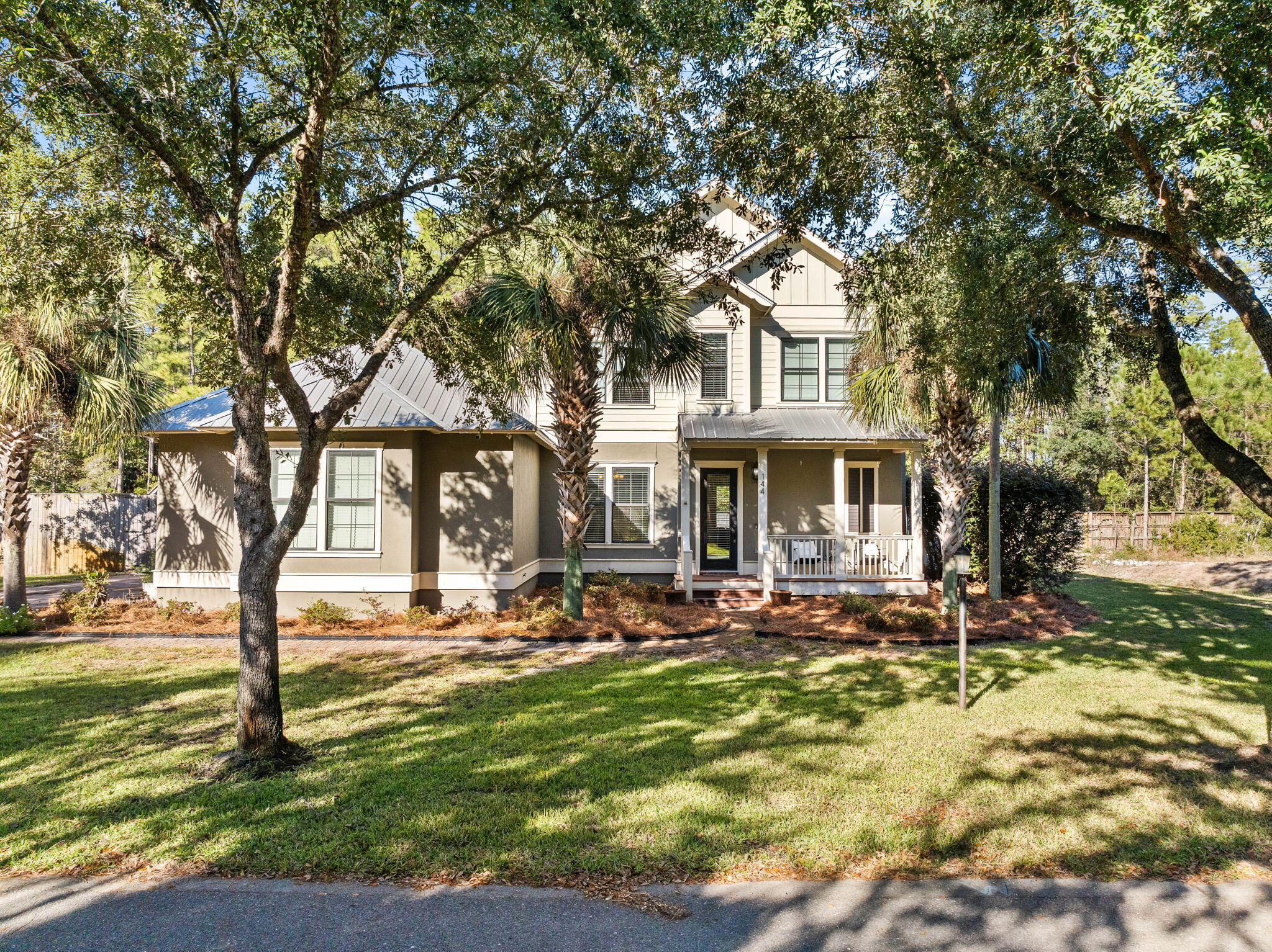 144 Preston Path Santa Rosa Beach, FL 32459 - Photo 6 of 60 a front view of a building with trees and umbrellas