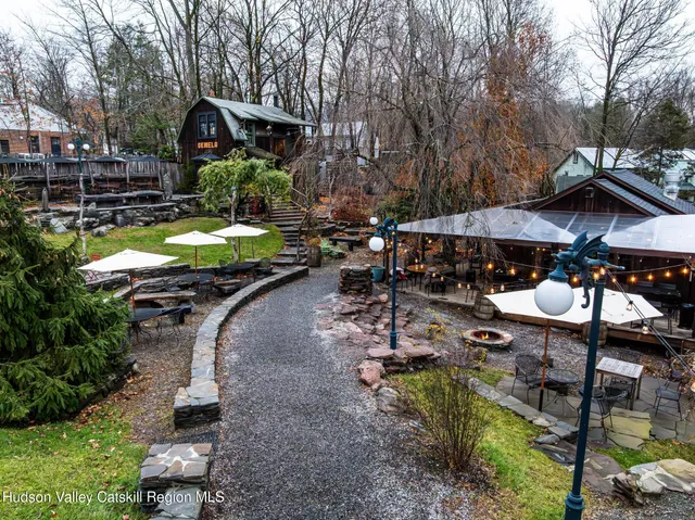 a view of a house with backyard swimming pool and sitting area