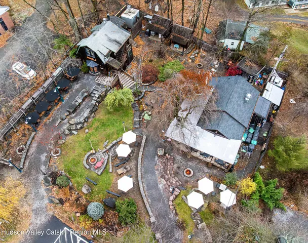 an aerial view of a house with a yard and sitting area