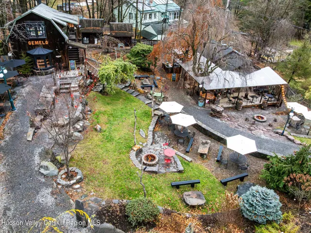 an aerial view of a house with garden space and trees