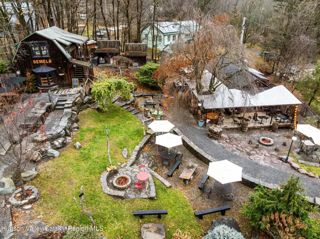 an aerial view of a house with a yard and lake view