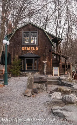 a view of a patio with table and chairs under an umbrella