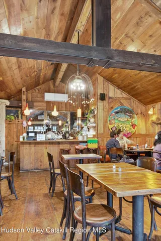a room with stainless steel appliances dining table and chairs