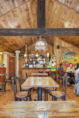 a living room with lots of furniture and a large window