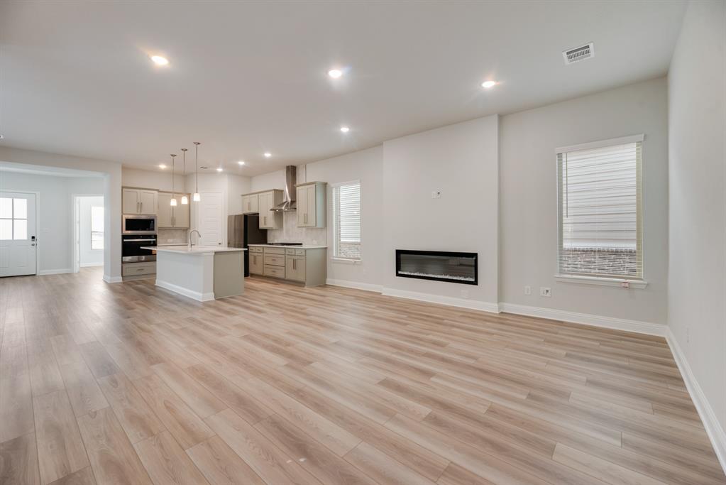 7009 Sunset Boulevard Rowlett, TX 75088 - Photo 16 of 35 an empty room with wooden floor and windows