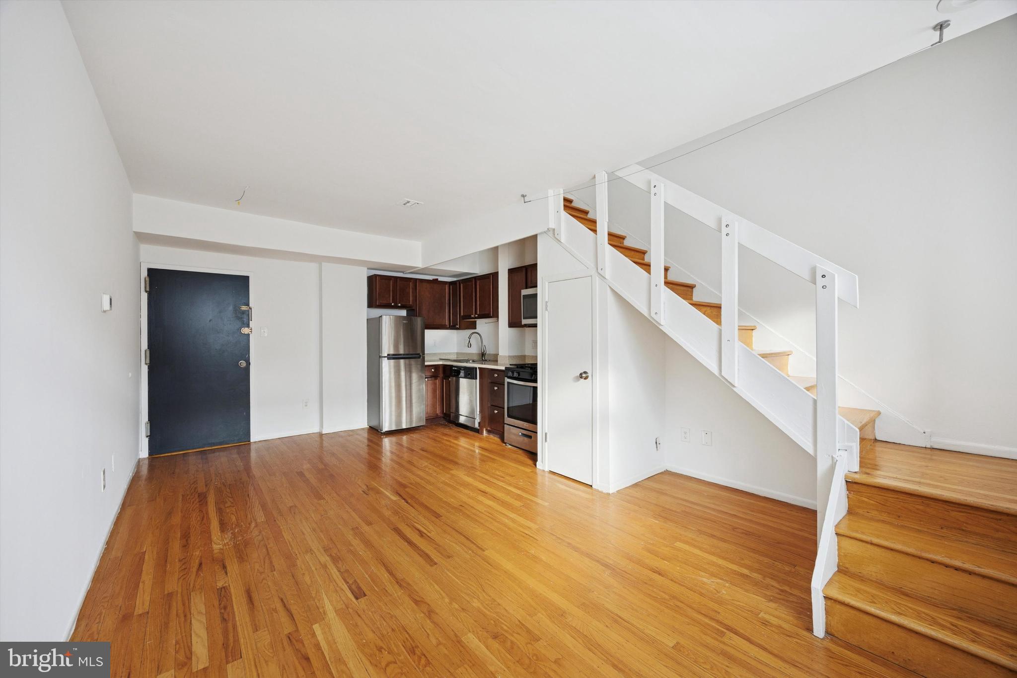 319 South 10th Street, Unit 335 Philadelphia, PA 19107 - Photo 1 of 15 a view of empty room with wooden floor and stairs