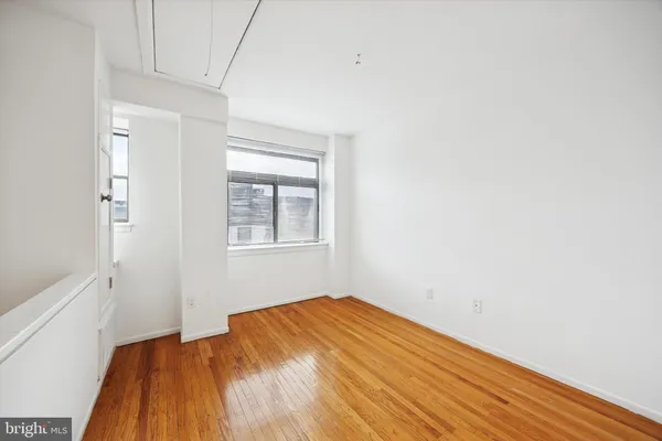 a view of a room with wooden floor and fan