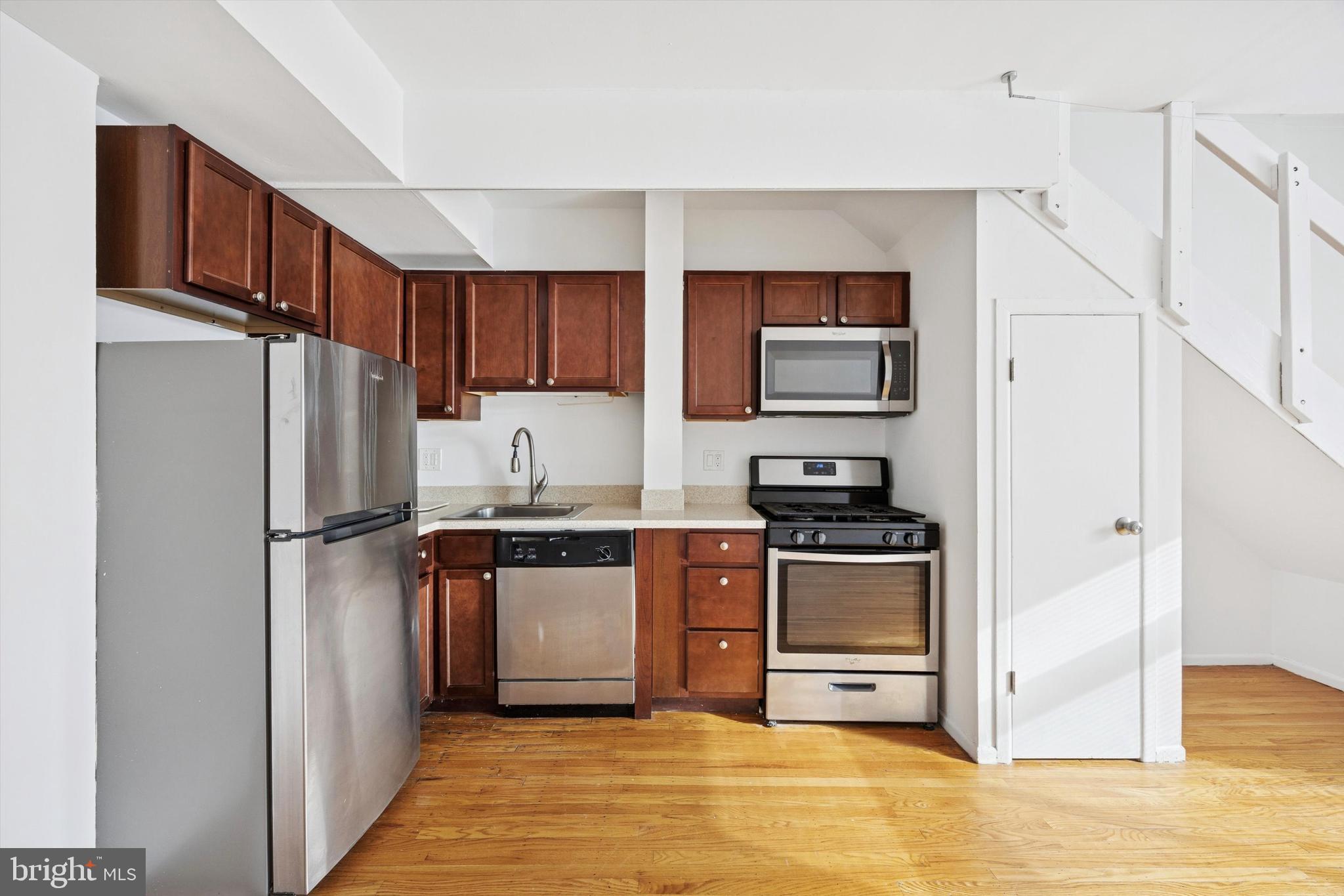 319 South 10th Street, Unit 335 Philadelphia, PA 19107 - Photo 6 of 15 a kitchen with stainless steel appliances granite countertop a refrigerator stove and a sink