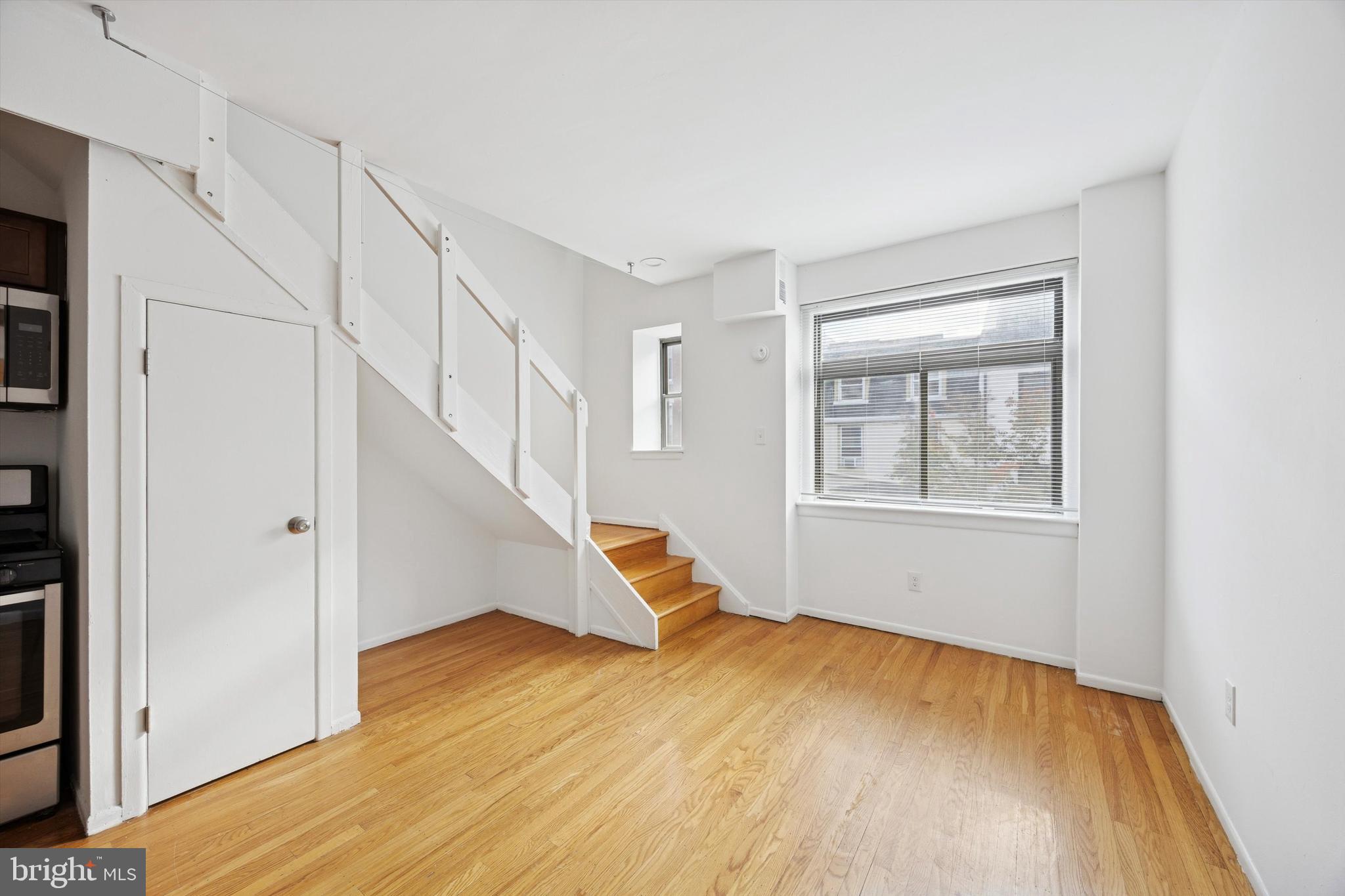 319 South 10th Street, Unit 335 Philadelphia, PA 19107 - Photo 8 of 15 a view of an empty room with wooden floor and a window