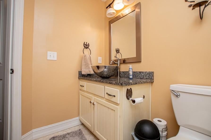 575 Liberty Church Road Carrollton, GA 30116 - Photo 45 of 95 a bathroom with a granite countertop sink vanity mirror and toilet