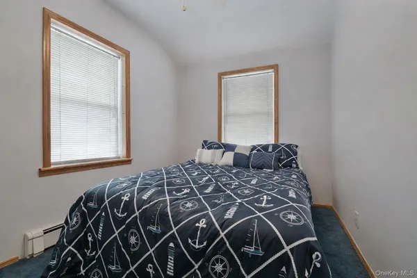 a bed sitting in a bedroom next to a window