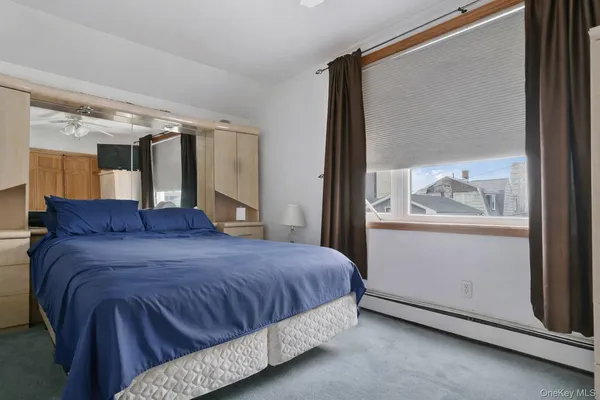 a bed sitting in a bedroom next to a window